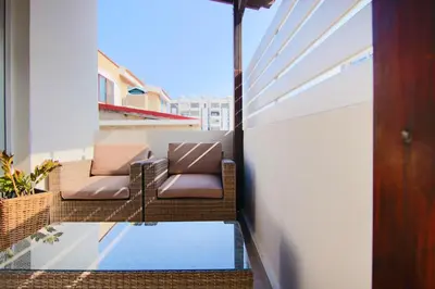 a balcony with two chairs and a pool at Phaedrus Living City View Luxury Flat Harbour 04 in Larnaka