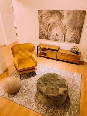 a living room with a chair and a table at Newly Renovated Super-Chic Apartment in Nicosia