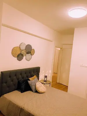 a bedroom with a bed with pillows on it at Newly Renovated Super-Chic Apartment in Nicosia