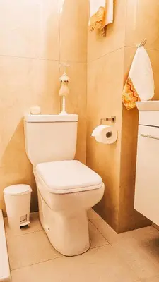 a bathroom with a white toilet and a sink at Newly Renovated Super-Chic Apartment in Nicosia