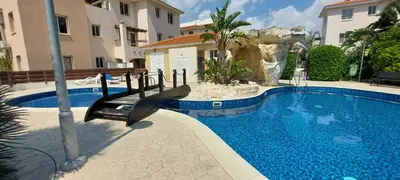 a swimming pool with a slide next to a building at Pyla Palms Resort - 1 bedroom in Pyla