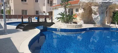 a swimming pool with a slide in a resort at Pyla Palms Resort - 1 bedroom in Pyla
