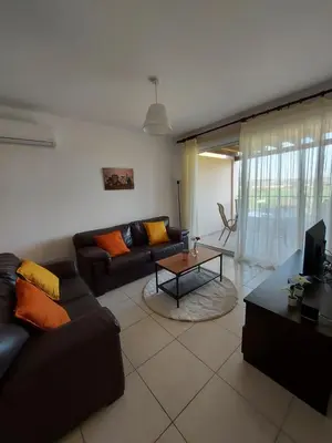 a living room with a couch and a table at Pyla Palms Resort - 1 bedroom in Pyla