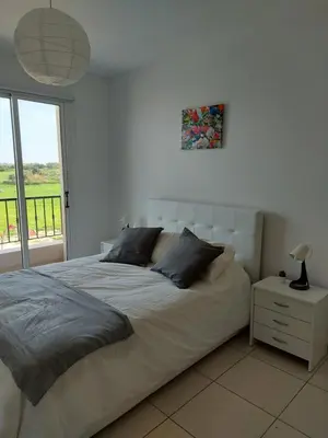 a white bedroom with a large bed and a window at Pyla Palms Resort - 1 bedroom in Pyla