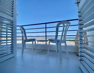 a balcony with two chairs and a table at Villa Kapparis Sunrise in Paralimni