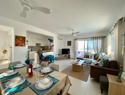 a living room with a table and a living room at Villa Kapparis Sunrise in Paralimni