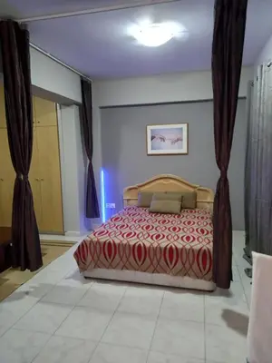 a bedroom with a bed in a room with curtains at Old Town studio apartment in Larnaka
