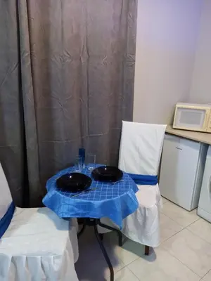 a table with two plates on top of it with two chairs at Old Town studio apartment in Larnaka
