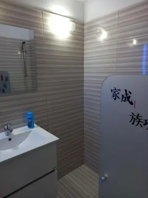 a bathroom with a sink and a shower with writing on the wall at Old Town studio apartment in Larnaka