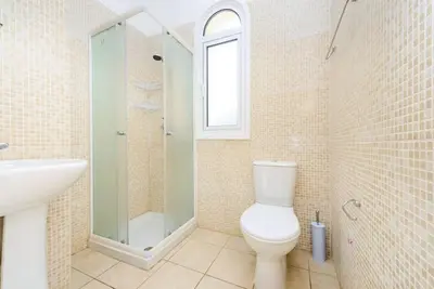 a bathroom with a toilet and a sink and a shower at Protaras Villa Athamas Blue in Protaras