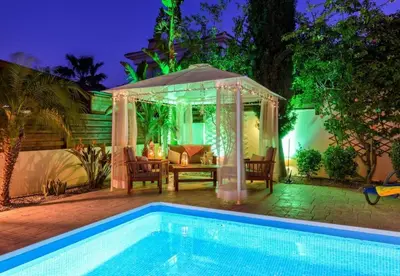 a swimming pool with a gazebo and a table at Protaras Villa Athamas Blue in Protaras