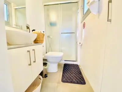 a bathroom with a shower and a toilet and a sink at Panoramic Seaside Getaway, 2-BR Penthouse in Larnaka