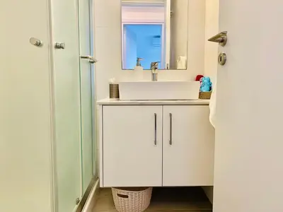 a bathroom with a sink and a mirror at Panoramic Seaside Getaway, 2-BR Penthouse in Larnaka