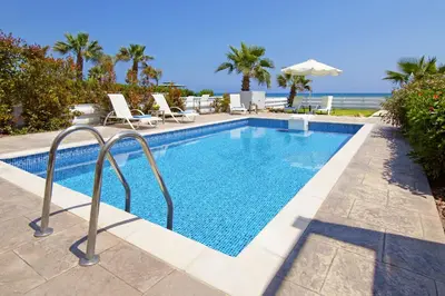 a swimming pool with a view of the ocean at Villa Aphrodisia - Seafront in Ayia Napa