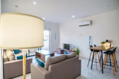 a living room with a couch and a table at Fanta Sea Apartment in Larnaka