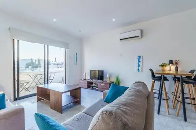 a living room with a couch and a table at Fanta Sea Apartment in Larnaka