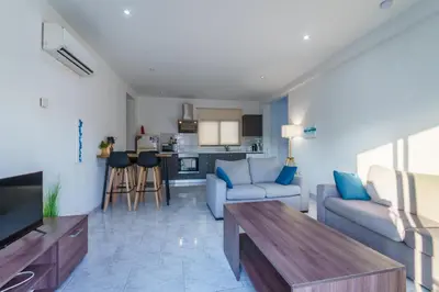 a living room with a couch and a table at Fanta Sea Apartment in Larnaka