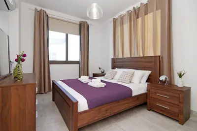 a bedroom with a bed with two towels on it at Villa Levandini in Protaras