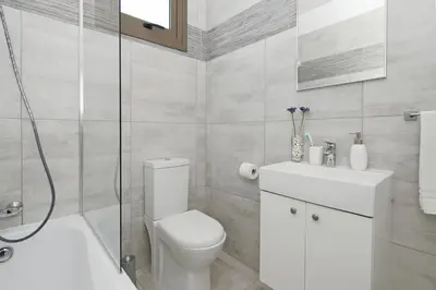 a bathroom with a toilet and a shower and a sink at Villa Levandini in Protaras