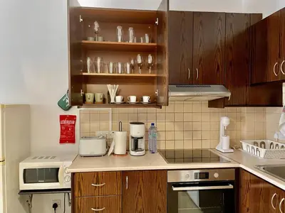 a kitchen with wooden cabinets and a counter top at Cyprus Penelope in Larnaka