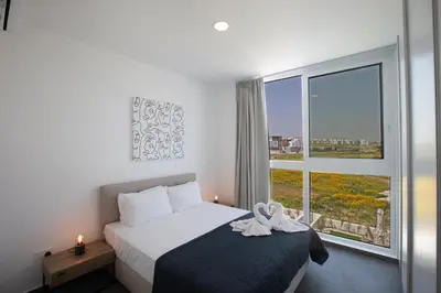 a bedroom with a bed and a large window at Vie Bleu 3 Bedroom Villas in Protaras