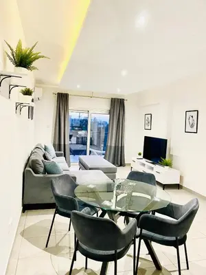 a living room with a couch and a table and chairs at Lina 703 in Larnaka