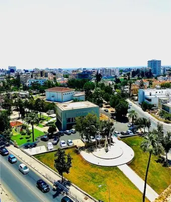 an aerial view of a city with cars on a street at Lina 703 in Larnaka