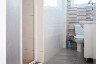 a bathroom with a toilet and a sink at Protaras View Villas in Protaras
