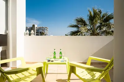 a patio with a table and chairs on a balcony at Protaras View Villas in Protaras