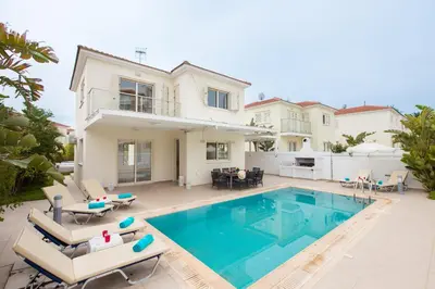 a villa with a swimming pool and a house at Pernera Holiday Villa 588 in Paralimni