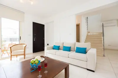 a living room with a white couch and a table at Pernera Holiday Villa 588 in Paralimni
