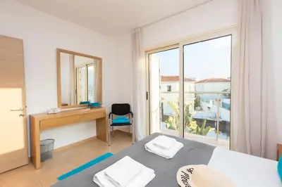 a bedroom with a bed and a desk and a window at Pernera Holiday Villa 588 in Paralimni