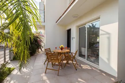 a patio with a table and chairs on a balcony at Pernera Holiday Villa 588 in Paralimni