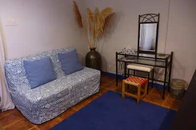 a living room with a couch and a table and a mirror at Kalimera A Lovely 1-bedroom rental with ensuite and Kitchen in Limassol