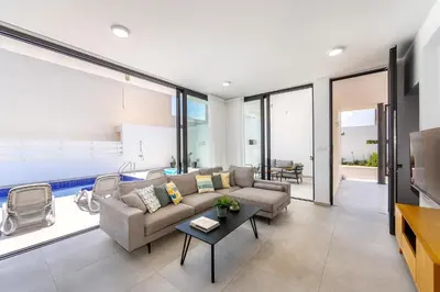 a living room with a couch and a table at Protaras Almaria Villa 16 in Protaras