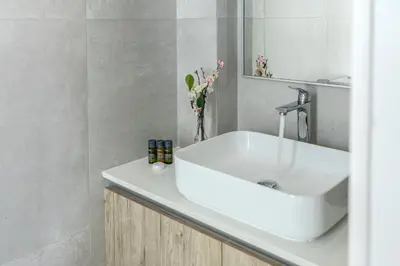 a bathroom with a white sink and a mirror at Protaras Almaria Villa 16 in Protaras