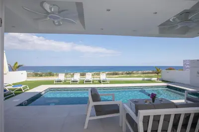 a swimming pool with a view of the ocean at Artizan Seafront Villa 5 in Protaras