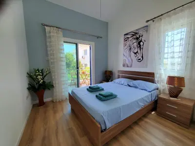 a bedroom with a bed and a large window at Villa - Sleeps 6 free parking & heated pool in Protaras