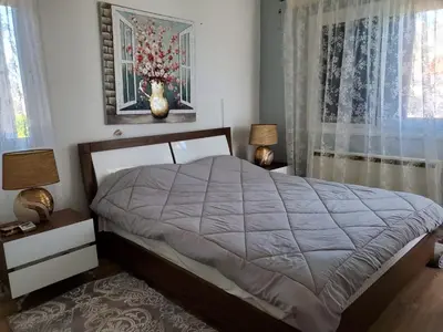 a bedroom with a bed and two lamps and a window at Villa - Sleeps 6 free parking & heated pool in Protaras