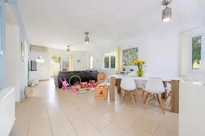 a kitchen and living room with a table and chairs at Villa Emily in Protaras