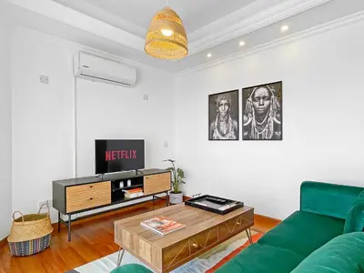 a living room with a green couch and a table at 180° SEAVIEW Apt. right on famous beach promenade in Larnaka