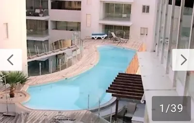 a large swimming pool in the middle of a building at City Flats 308 in Larnaka