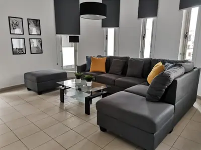 a living room with a couch and a table at City Flats 308 in Larnaka