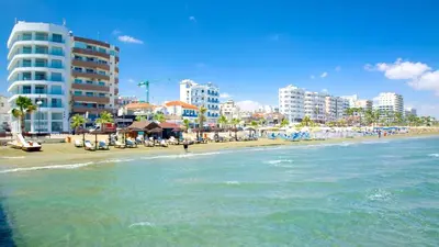 a beach with buildings and the ocean and the ocean at City Flats 308 in Larnaka