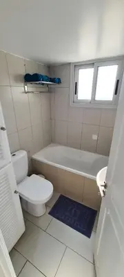 a bathroom with a toilet and a tub and a sink at Lovely 1betroom apartment near the beach in Pyla