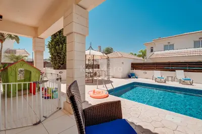 a house with a swimming pool and a house at Villa Hanna in Protaras