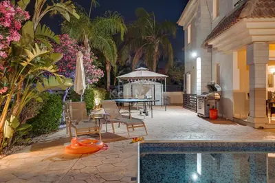 a backyard with a pool and a table and chairs at Villa Hanna in Protaras