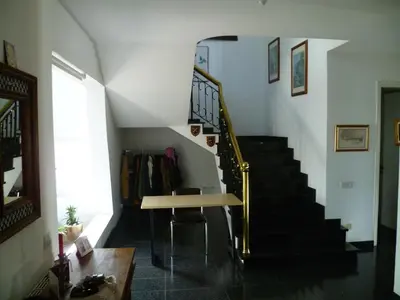 a room with a staircase with a table and a stair case at Datacom House - The Sky Blue Room in Nicosia