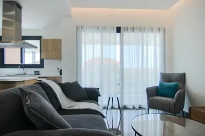 a living room with a couch and a table at Phaedrus Living: City View Anna Residence 101 in Limassol