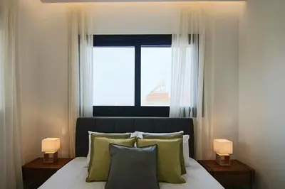 a bedroom with a bed with a large window at Phaedrus Living: City View Anna Residence 101 in Limassol